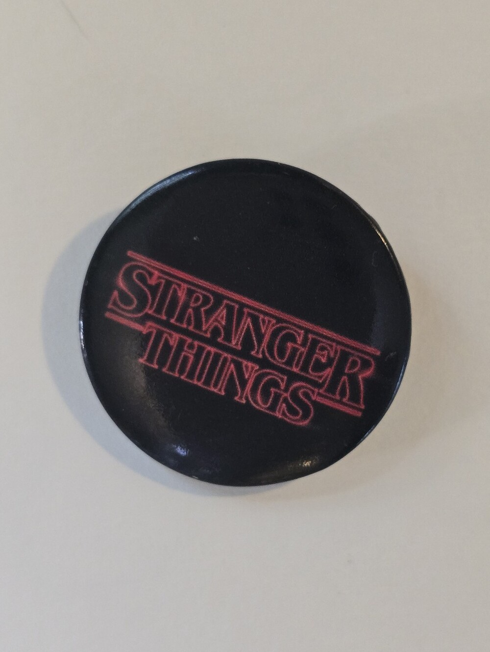 Stranger Things Black Button Pin with Red Logo